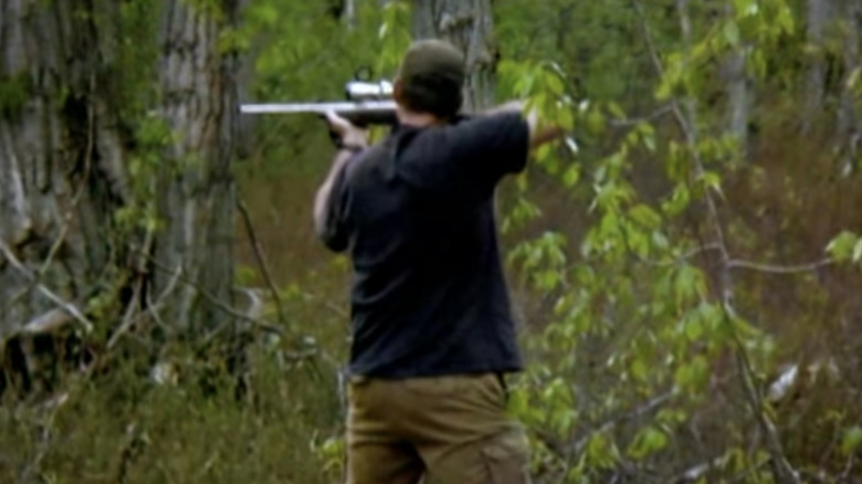 Gold Rush miner shooting a black bear