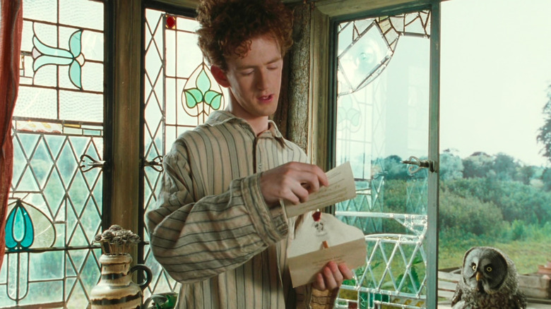 Percy holding letter from Hogwarts