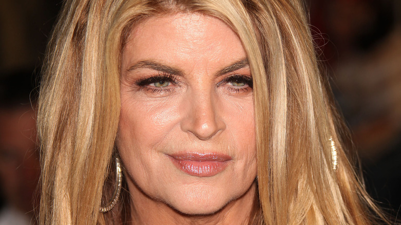 Kirstie Alley smiling and looking down