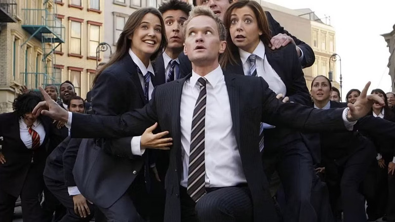 Robin Ted Marshall Lily behind Barney all wearing suits on How I Met Your Mother