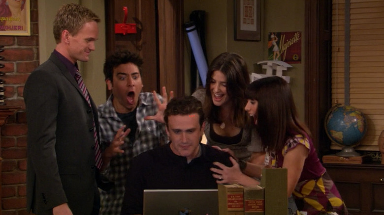 Barney Ted Robin Lily and Marshall looking at a computer on How I Met Your Mother