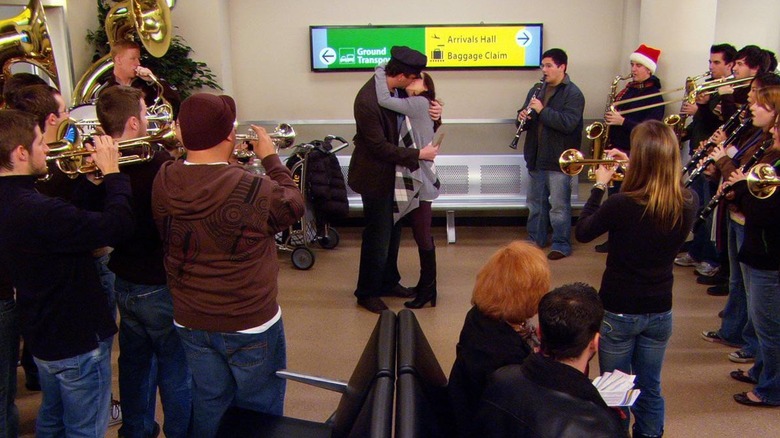 Lily and Marshall kissing at the airport surrounded by a marching band on How I Met Your Mother