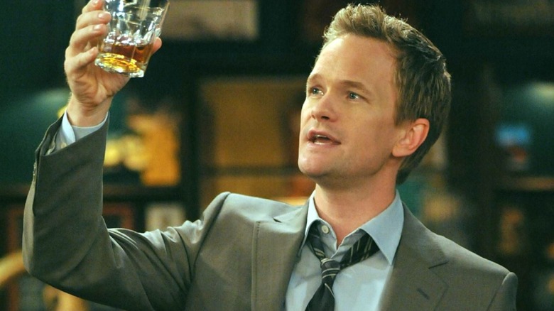 Barney holding up a scotch in How I Met Your Mother
