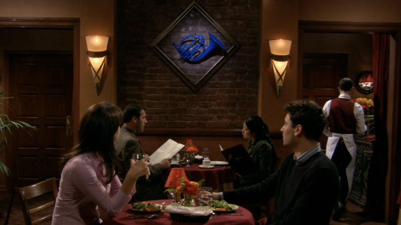 Josh Radnor as Ted Mosby, holding the blue French horn in How I Met Your Mother