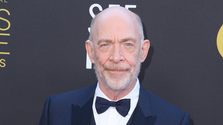 J.K. Simmons posing in blue suit
