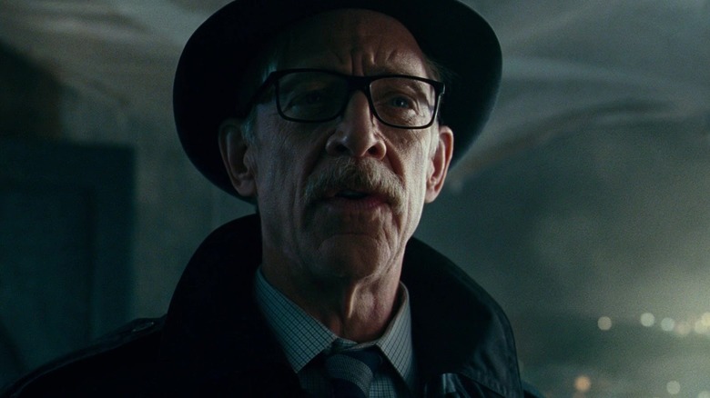 J.K. Simmons wearing hat and coat as Commissioner Gordon