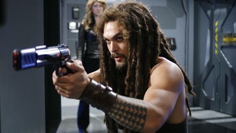 Dex aims a gun on the ship in Stargate: Atlantis