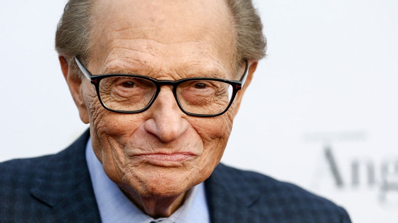 Larry King black glasses smiling