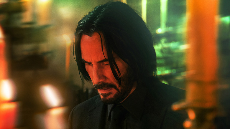 John Wick surrounded by candles