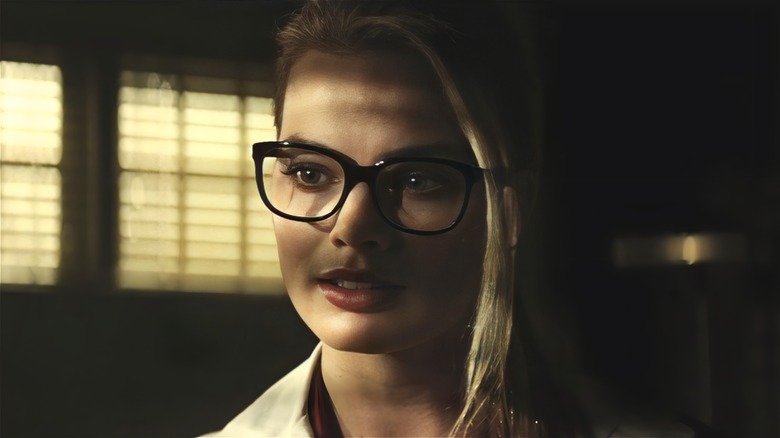 Dr. Harleen Quinzel sits in the shadows 