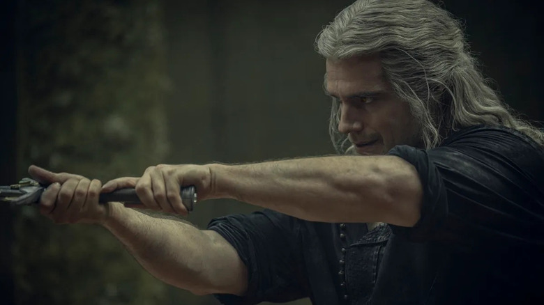 Henry Cavill brandishes a sword as Geralt in The Witcher