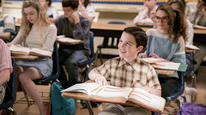 Young Sheldon in class smiling
