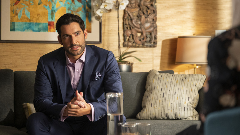 Lucifer sits across from someone