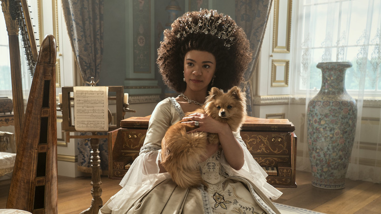 Young Queen Charlotte sitting holding dog