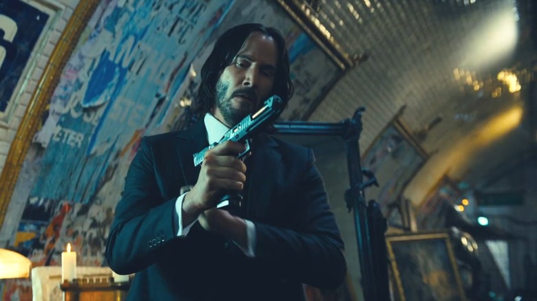 John Wick loads a pistol in "John Wick: Chapter 4" (2023)