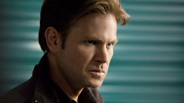 Alaric glowering by some lockers in 