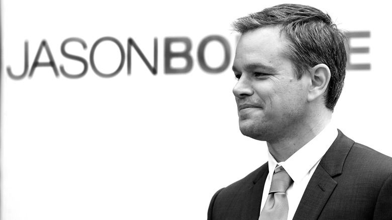 Matt Damon in front of a marquee for "Jason Bourne"