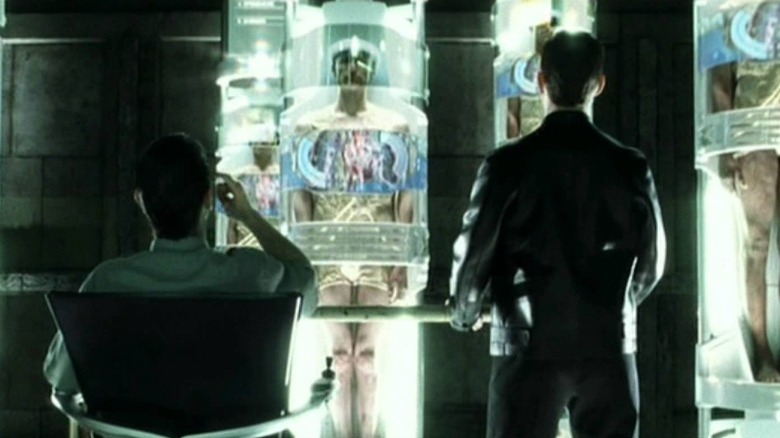 two men view prisoners in pods