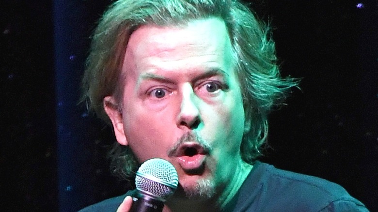 David Spade performing with microphone