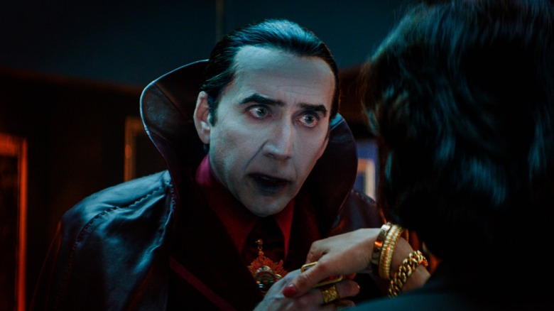 Dracula mesmerizing someone before he kisses their hand