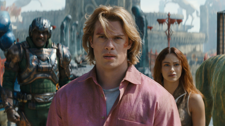 Adam stands in front of Man-At-Arms and Teela in 