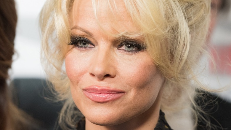 Pamela Anderson smiling on red carpet