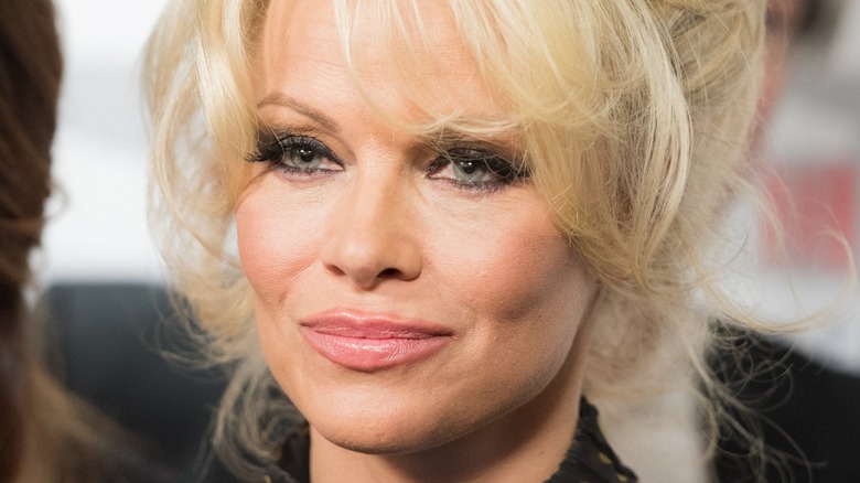Pamela Anderson smiling on red carpet