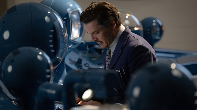 Reed Richards surrounded by astronaut helmets in "The Fantastic Four: First Steps" (2025)