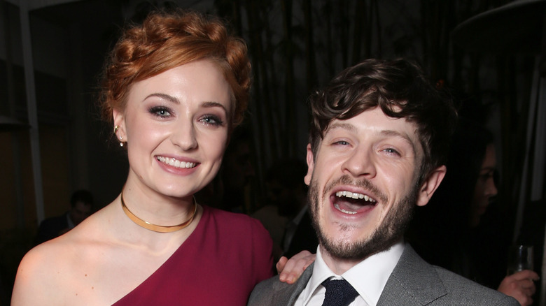 Sophie Turner and Iwan Rheon smiling together