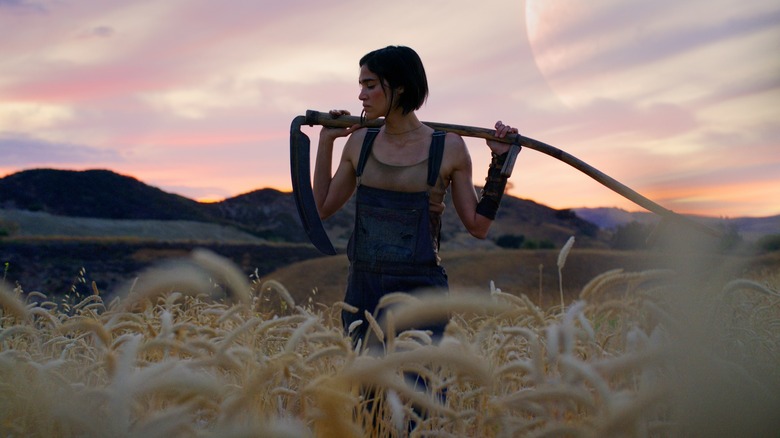 Kora holds her scythe