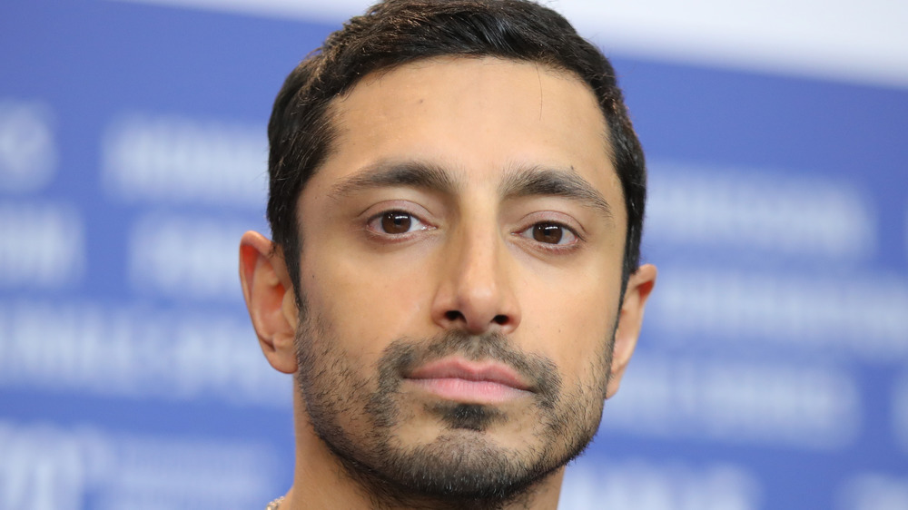 Riz Ahmed staring