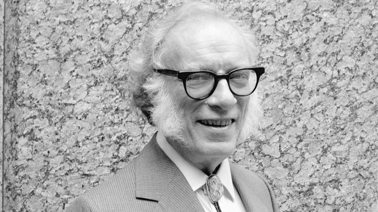 Dr. Isaac Asimov smiling in a suit and bolo tie