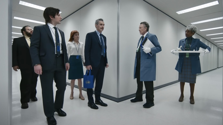 Lumon employees standing in the hallway