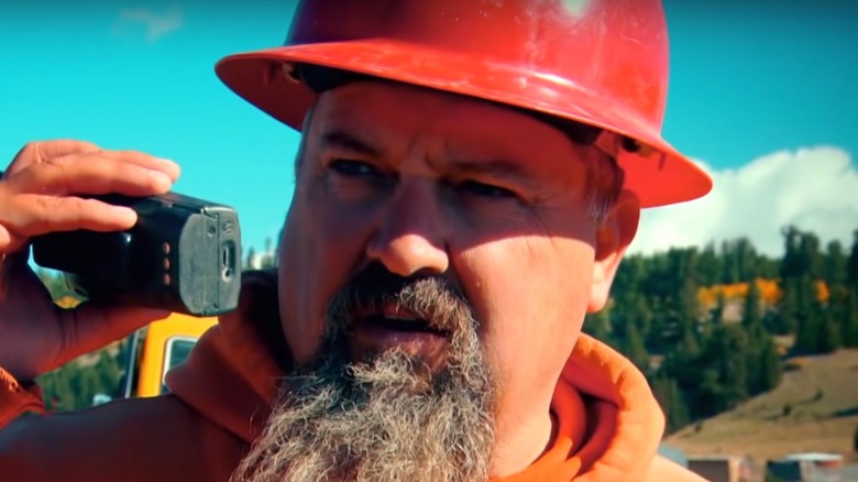 Todd Hoffman in orange hardhat, talking on radio