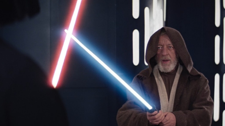 Obi-Wan Kenobi holding his lightsaber