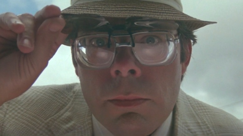 Stephen King peering at an ATM in 