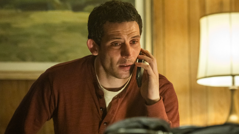 Daniel Kellner talking on the phone in a hotel room in 
