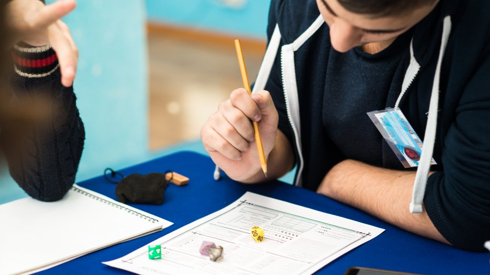 A player fills out a Dungeons & Dragons character sheet
