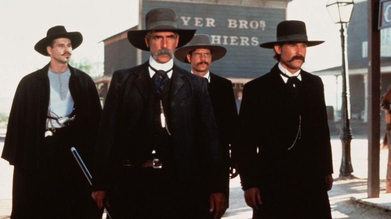The Earps and Doc Holiday walk through town in Tombstone