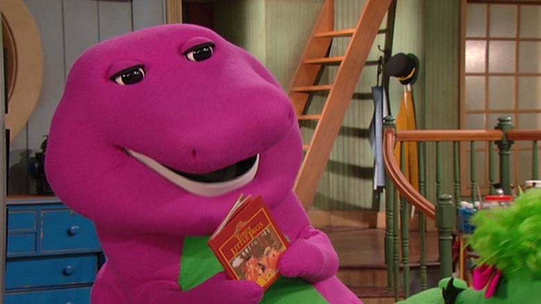 Barney holding a book