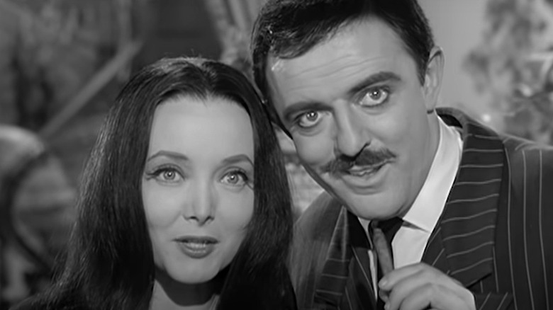 Morticia and Gomez spying together