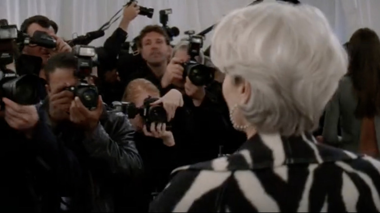 Meryl Streep posing in front of paparazzi as Miranda Priestly