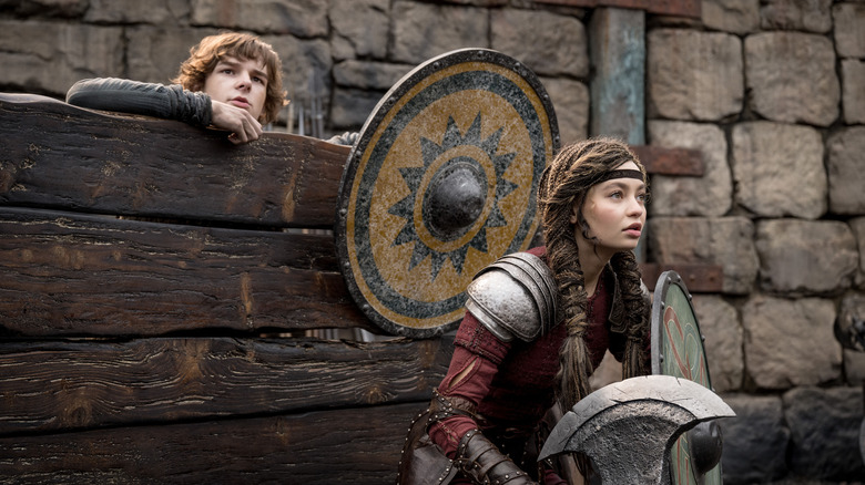 Hiccup hiding behind barricade while Astrid prepares to fight (2025)
