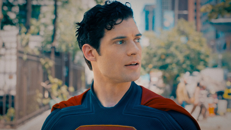 Superman stands in the street and turns his head in Superman (2025)