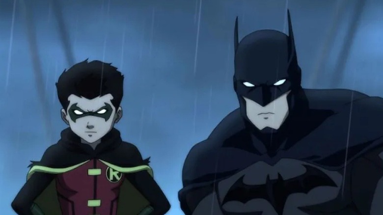 Batman and Robin observe the street below in the rain in Batman vs. Robin
