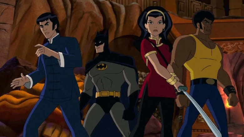 Batman, Richard, Ben, and Lady Shiva prepare to fight in a cave in Batman: Soul of the Dragon