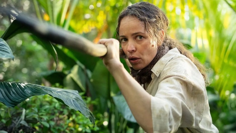 Linda holding a large stick in the jungle in "Send Help"
