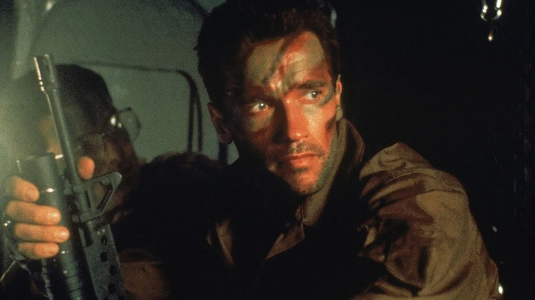 Camouflaged Dutch holds a firearm in Predator (1987)