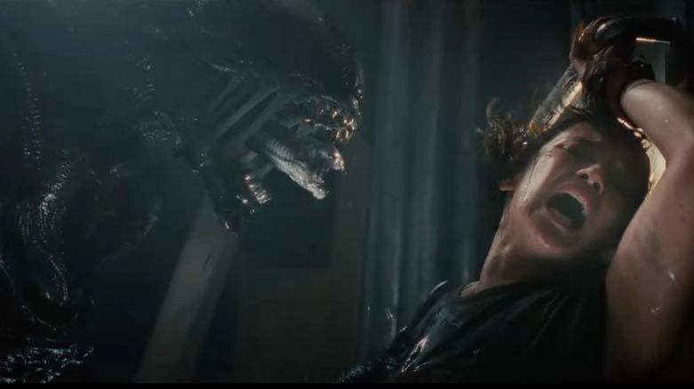 Rain is braced by a bioengineered xenomorph in Alien: Romulus