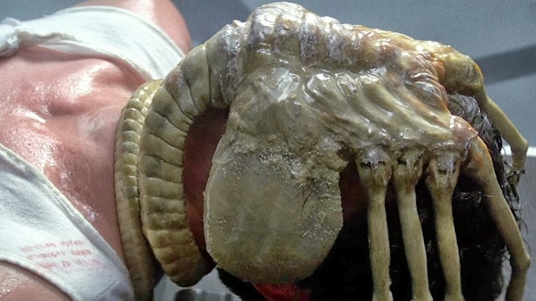 Kane is prone under a facehugger in Alien (1979)